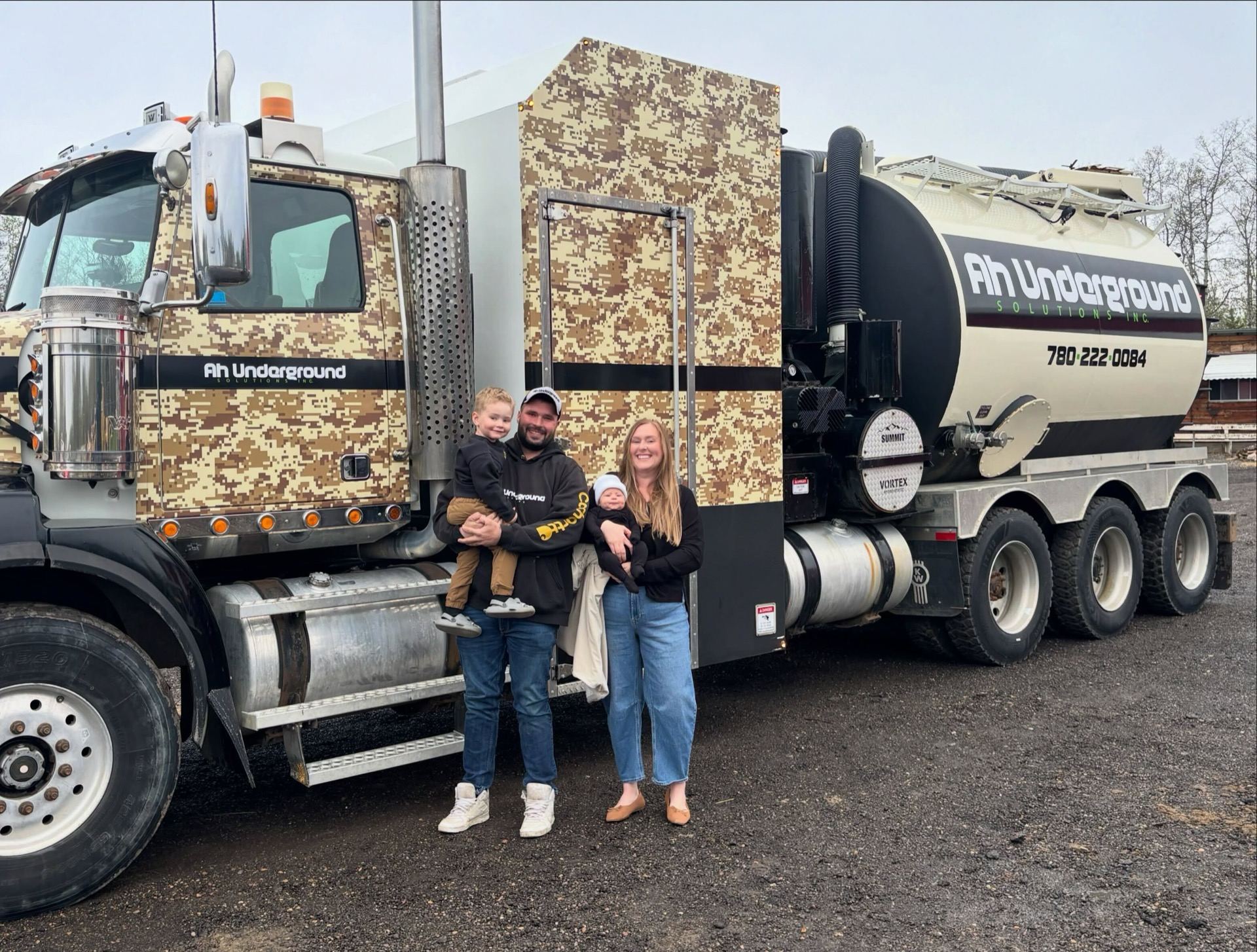 AH Underground owners and family in front of their hydrovac truck